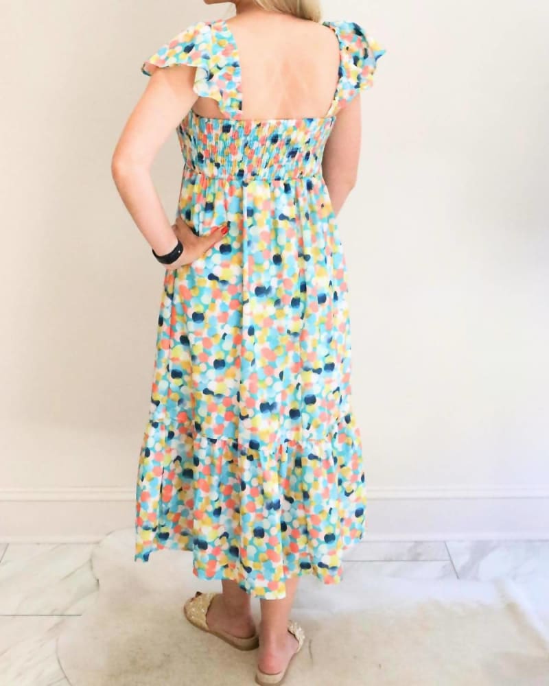 Back of a model wearing a size Large Polka Dot Smocked Midi Dress in Multi in Multi by THML. | dia_product_style_image_id:334948